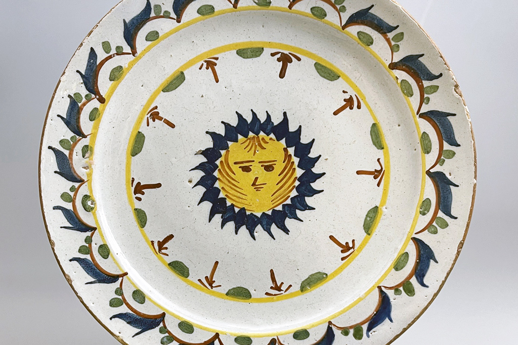 English delftware polychrome plate sun image mid 18th century