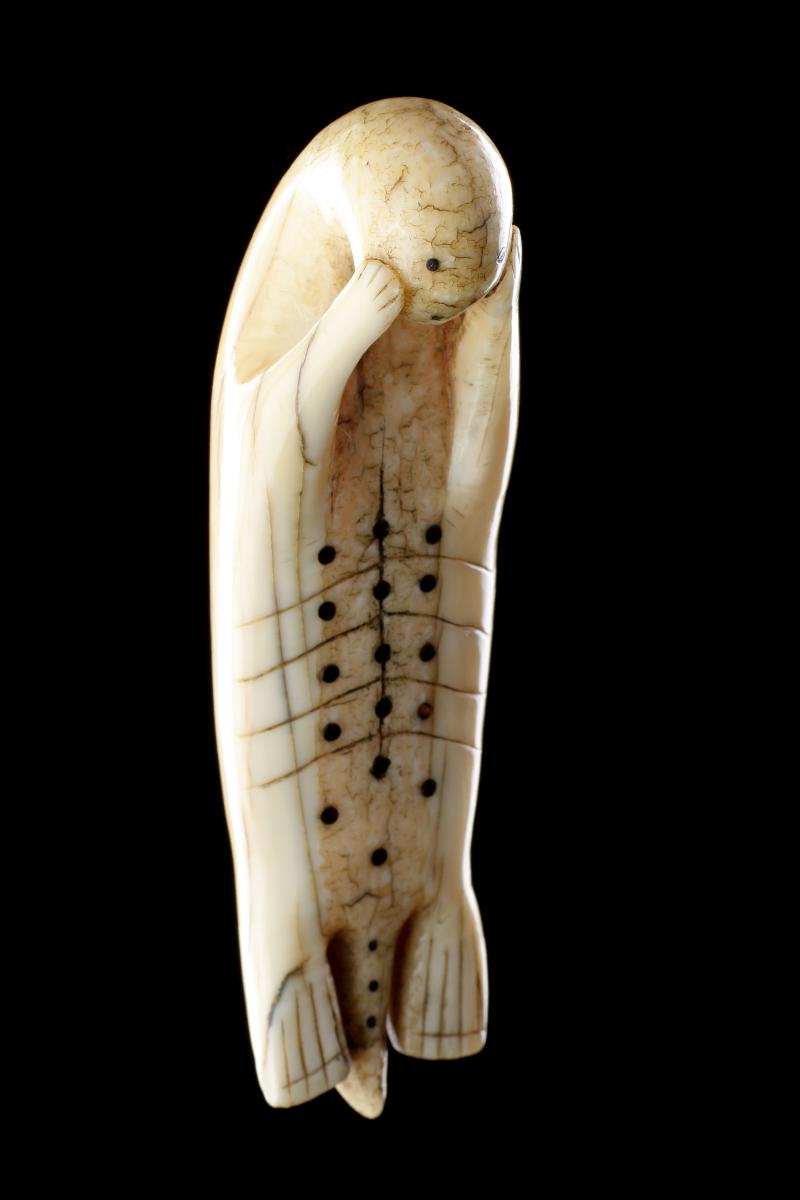 Inuit Amulet of a Seal Laying on His Back with Flippers Cradling His Face