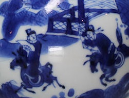 A detail view of a Kangxi blue and white porcelain decoration featuring two characters in a Love Chase