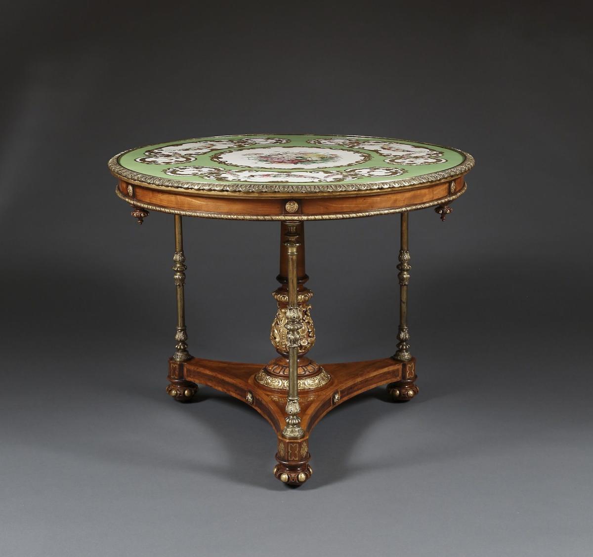 A Satinwood And Gilt-Brass Mounted Circular Center Table Bearing An Exquisite 'Adelaide Green' Porcelain Top By Copeland & Garrett  