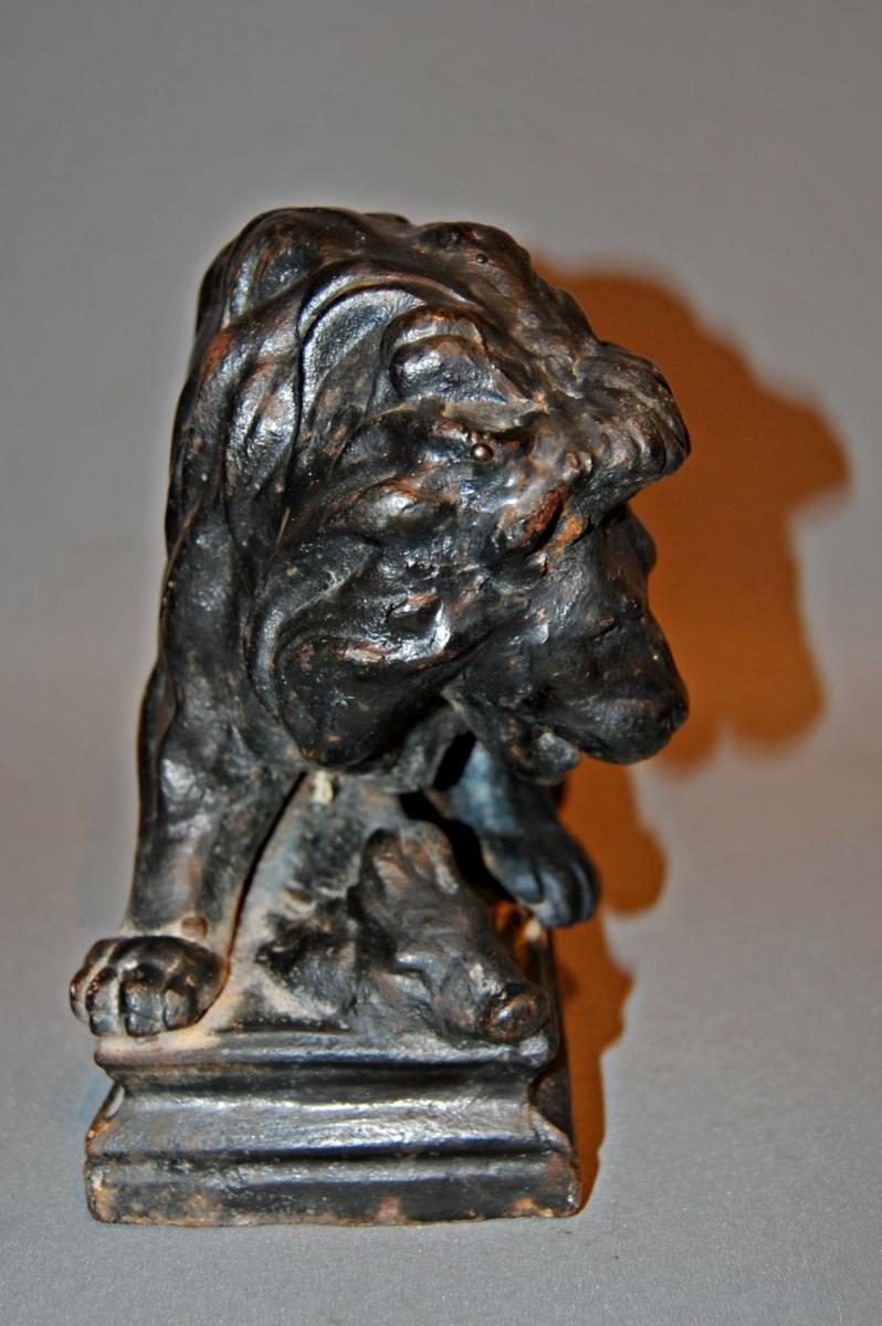 cast iron C19th doorstop depiction a large lion with its prey, a wild boar, at its mercy.