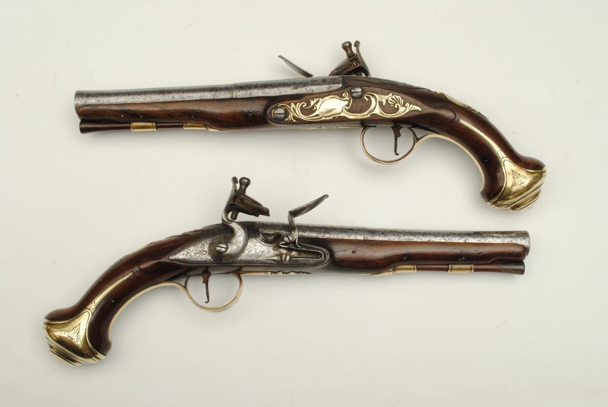A pair of brass mounted 22 bore gentleman's holster pistols