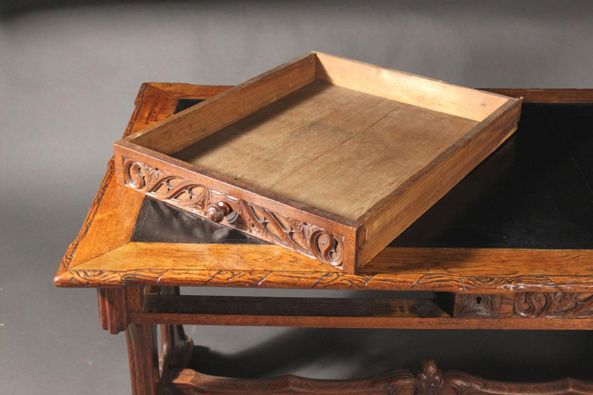 A neo-Gothic carved oak writing table