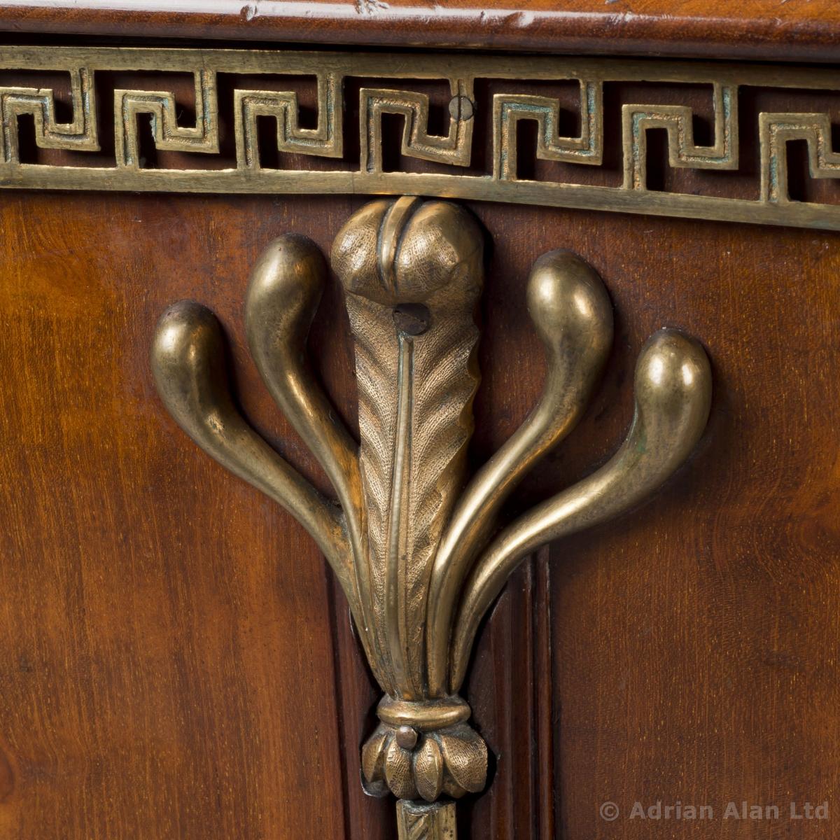 A detail of a Rare Pair of Late George III Gilt-Bronze Mounted Mahogany Cellarettes