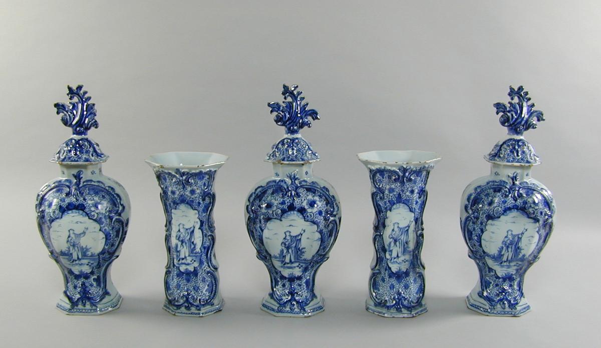 A Garniture of mid 18th century Dutch Delft blue and white vases