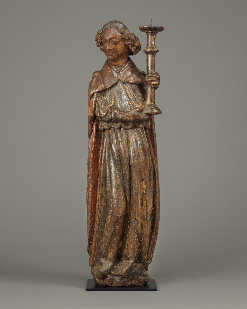 Angel Holding Candlestick  Oak, with original polychrome and traces of gilding England, c. 1420
