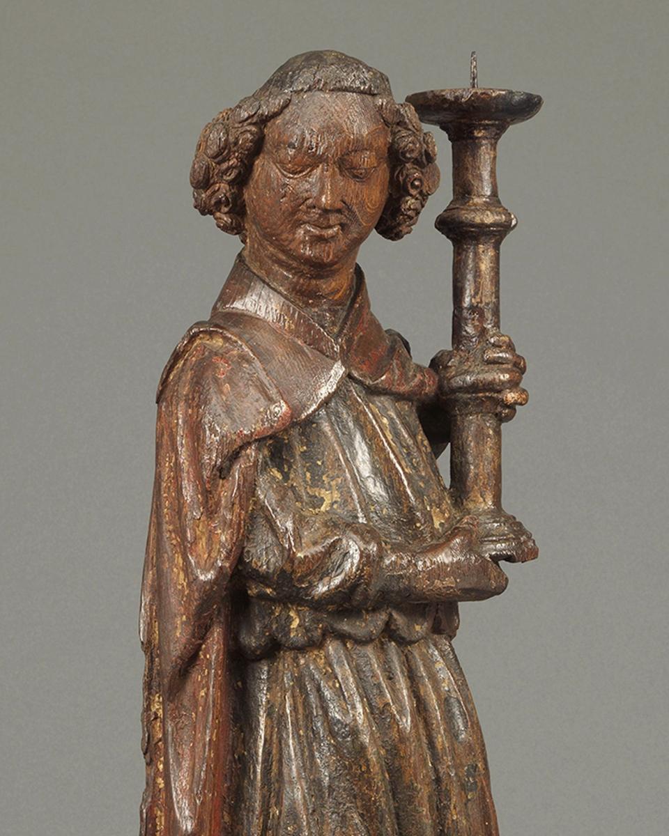 Angel Holding Candlestick  Oak, with original polychrome and traces of gilding England, c. 1420