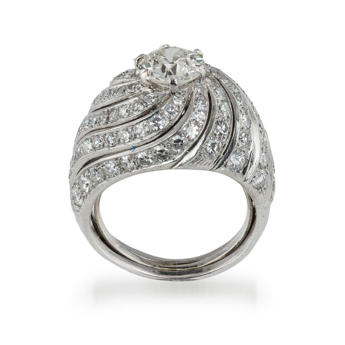 A French platinum set bombe style ring with a central diamond of 1.50 carat