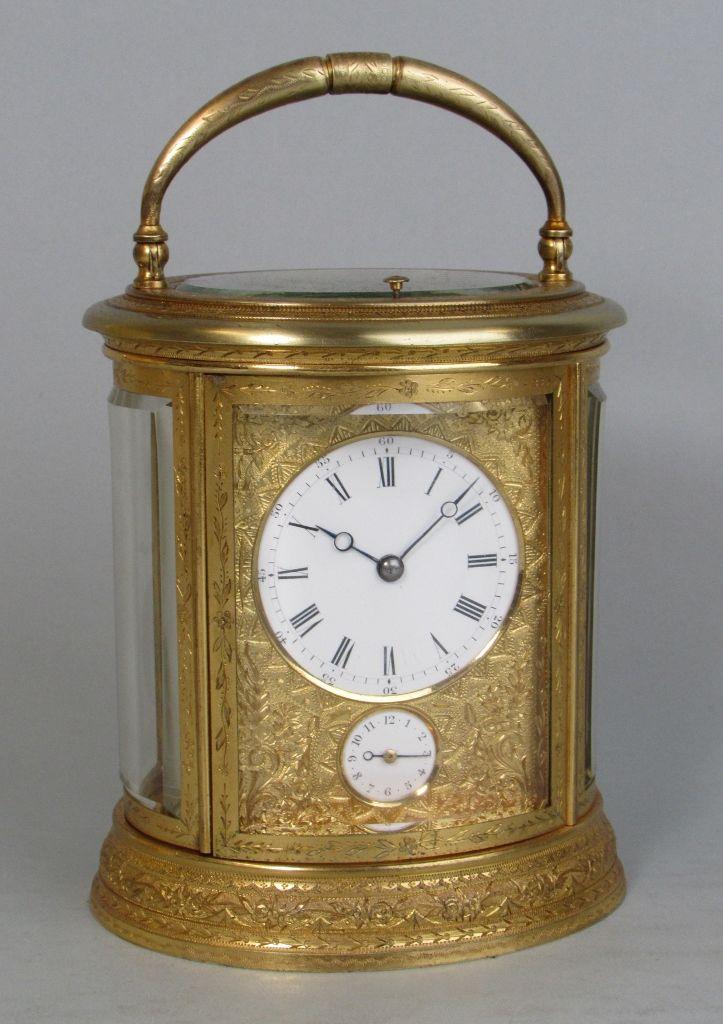Drocourt An engraved oval carriage clock