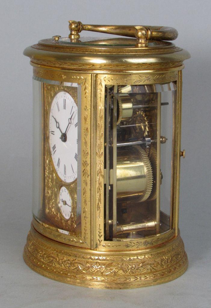 Drocourt An engraved oval carriage clock side