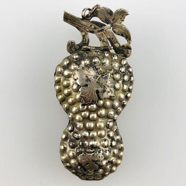 A repoussé silver gilt pendant in the form of a bunch of grapes.German, 19th century