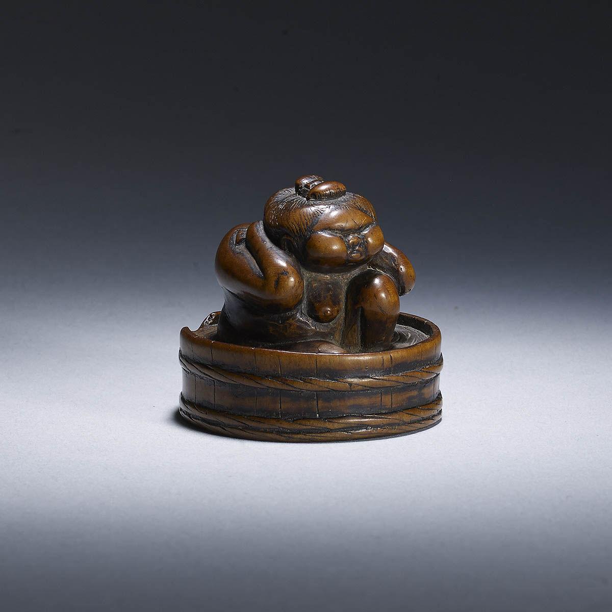 Wood netsuke of Okame in her bath