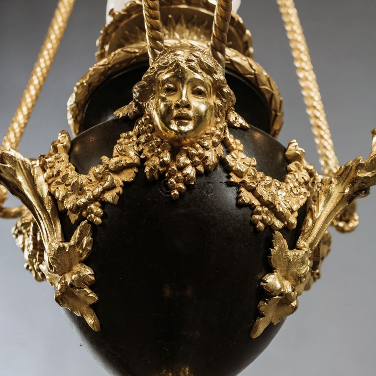 A Louis XVI Style Gilt and Patinated Bronze Four-Light Chandelier