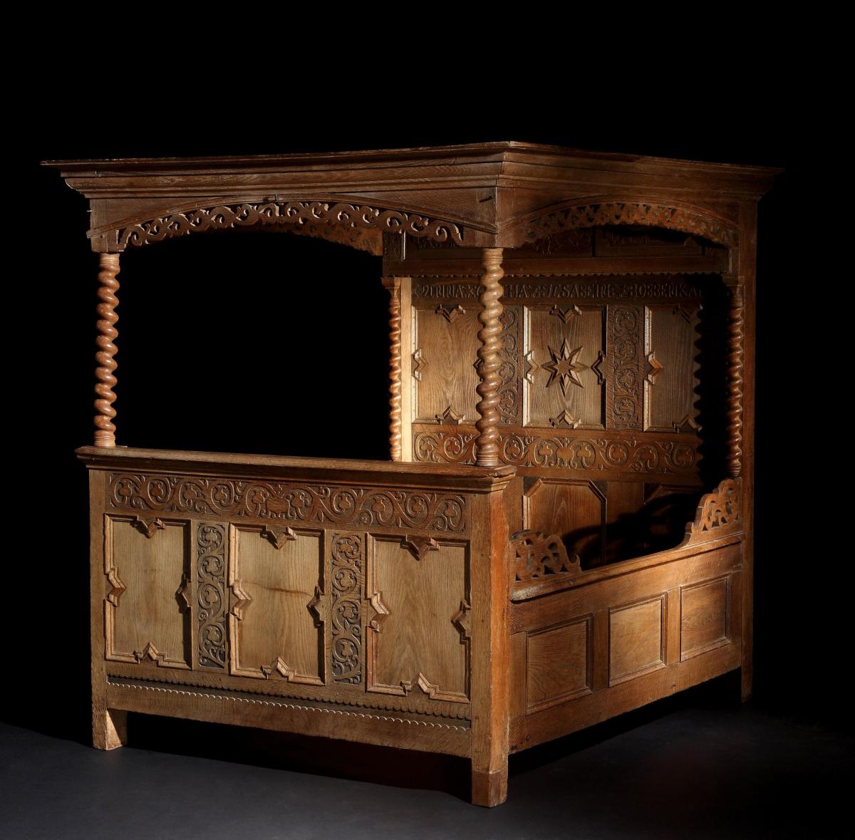 A mid-17th century, oak, tester, double bed with cupboard in the headboard, retaining its original iron fasteners, reputedly fro