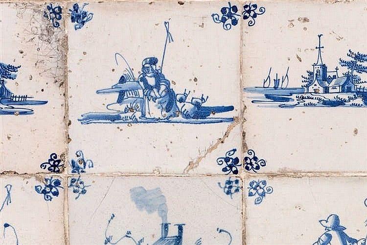 A stone plaque containing fourteen 18th century blue and white delft tiles