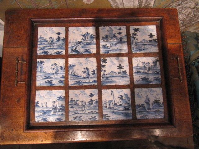 A set of twelve, 18th century, delftware tiles, unusually, made into an oak tray, probably during the early-20th century