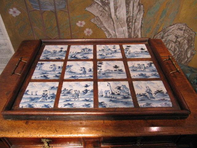 A set of twelve, 18th century, delftware tiles, unusually, made into an oak tray, probably during the early-20th century