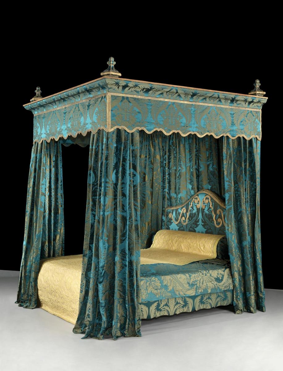 A massive, 19th century, State Bed re-upholstered in a blue, silk damask brocade