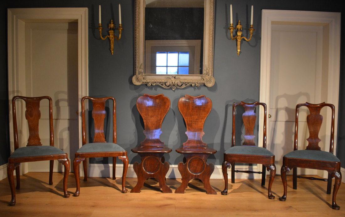 A fine pair of mahogany hall chairs of Scabello form with dished backs