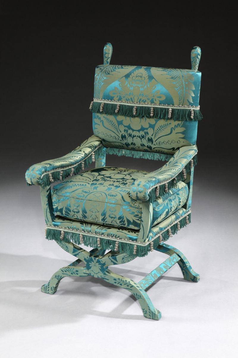 A 19th century ‘ X ‘ chair, re-upholstered in a green, silk damask 