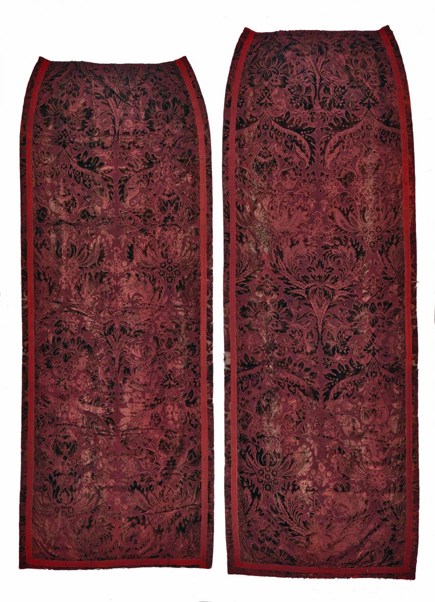 Three burgundy coloured, cut and uncut velvet curtains, circa 1900, from Cowdray Park