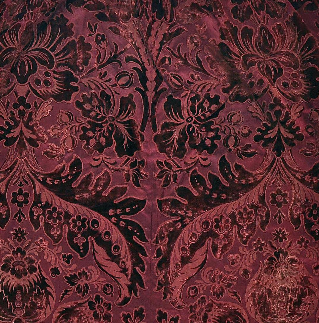 Three burgundy coloured, cut and uncut velvet curtains, circa 1900, from Cowdray Park