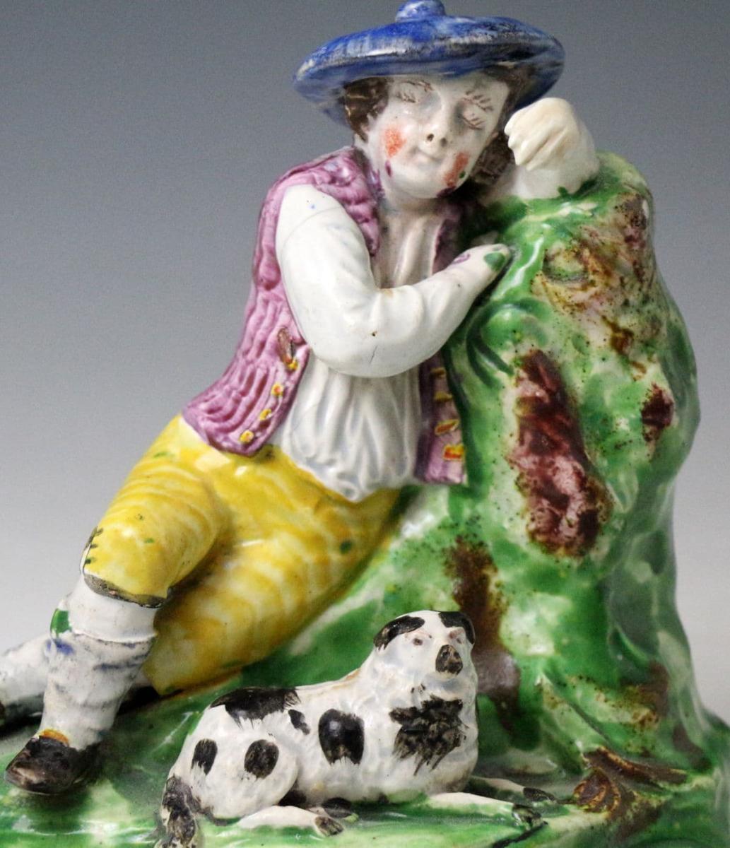 Antique Staffordshire pottery figure of a shepherd boy and his dog, early 19th century