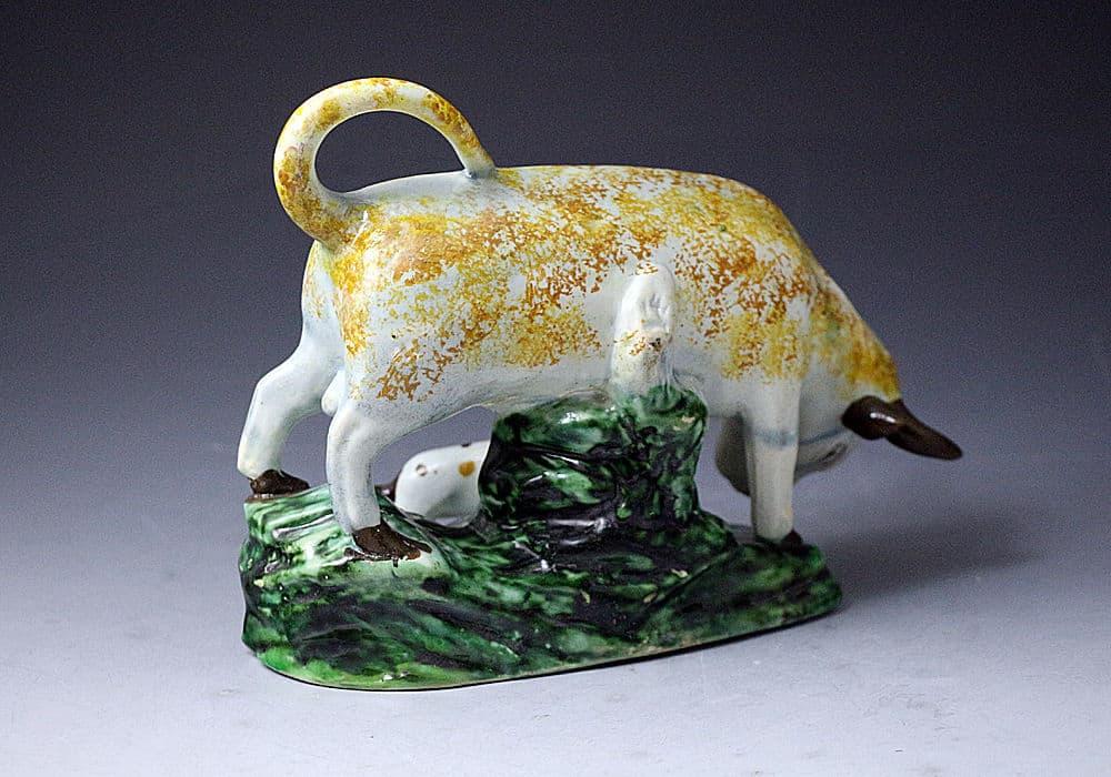 Staffordshire pottery pearlware figure of a bull and terrier on green base, late 18th century England