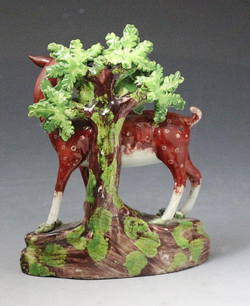 Staffordshire pearlware pottery bocage figure of a doe deer standing on a base, antique period early 19th century