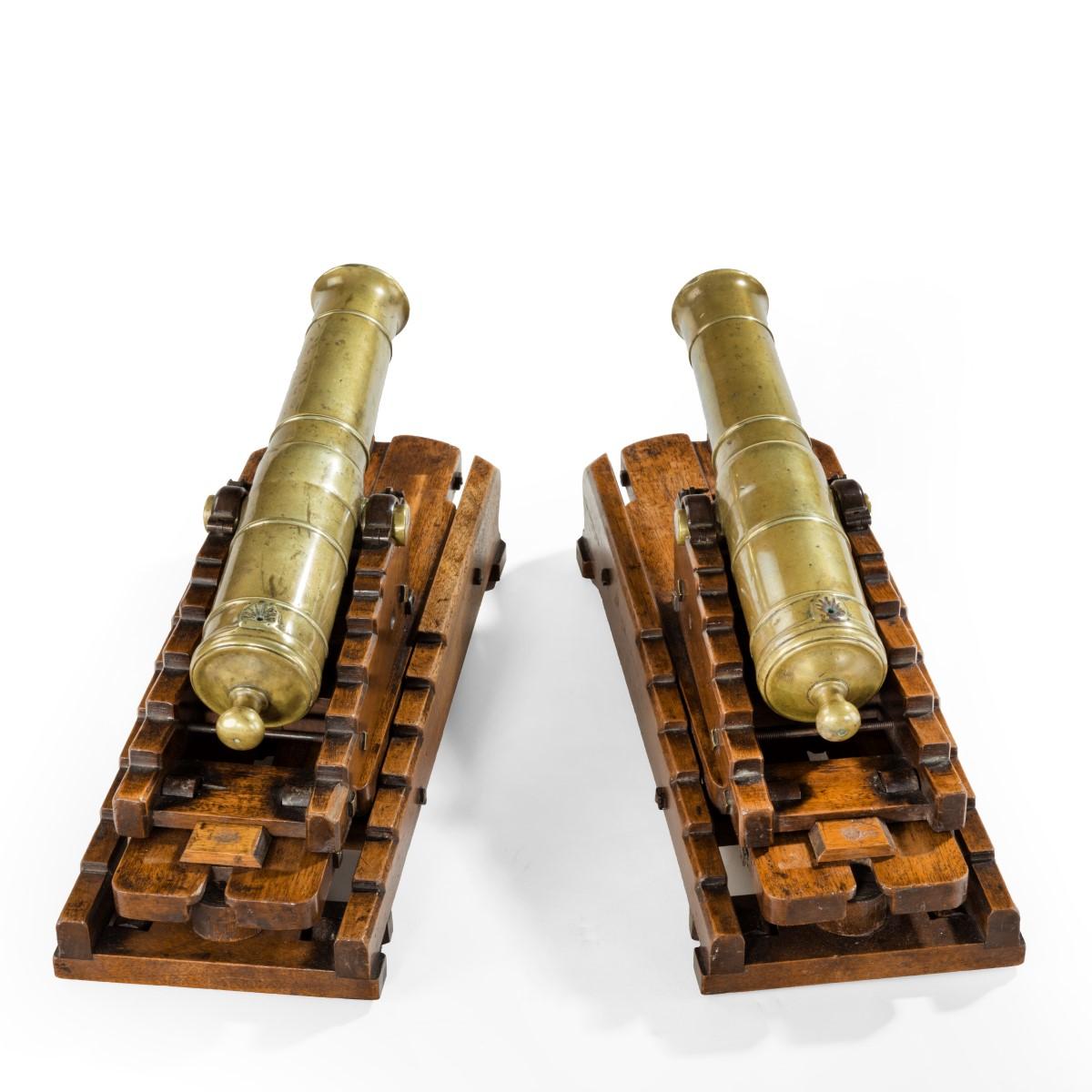 A pair of brass 19th century models of ship’s 32-pounder cannon