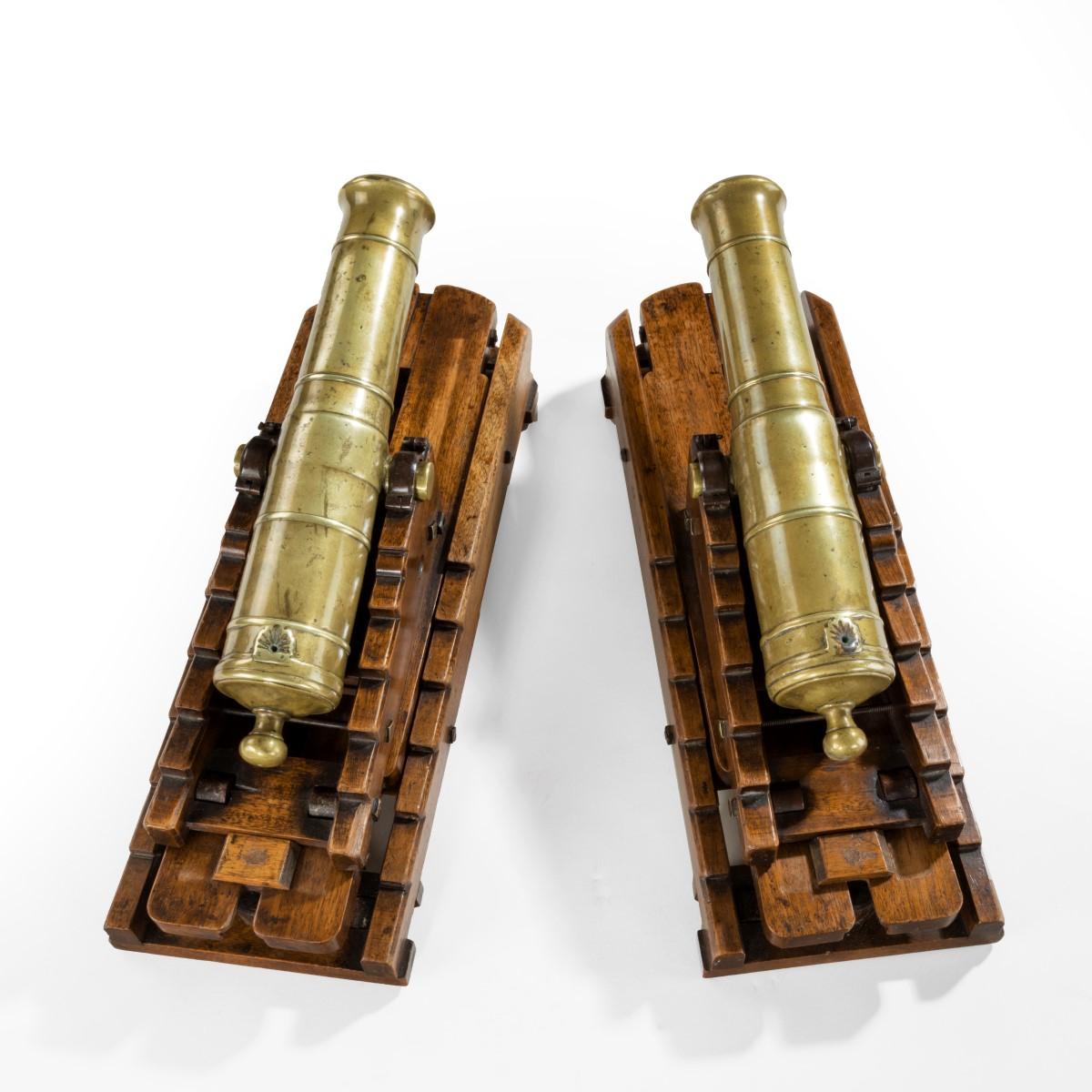 A pair of brass 19th century models of ship’s 32-pounder cannon
