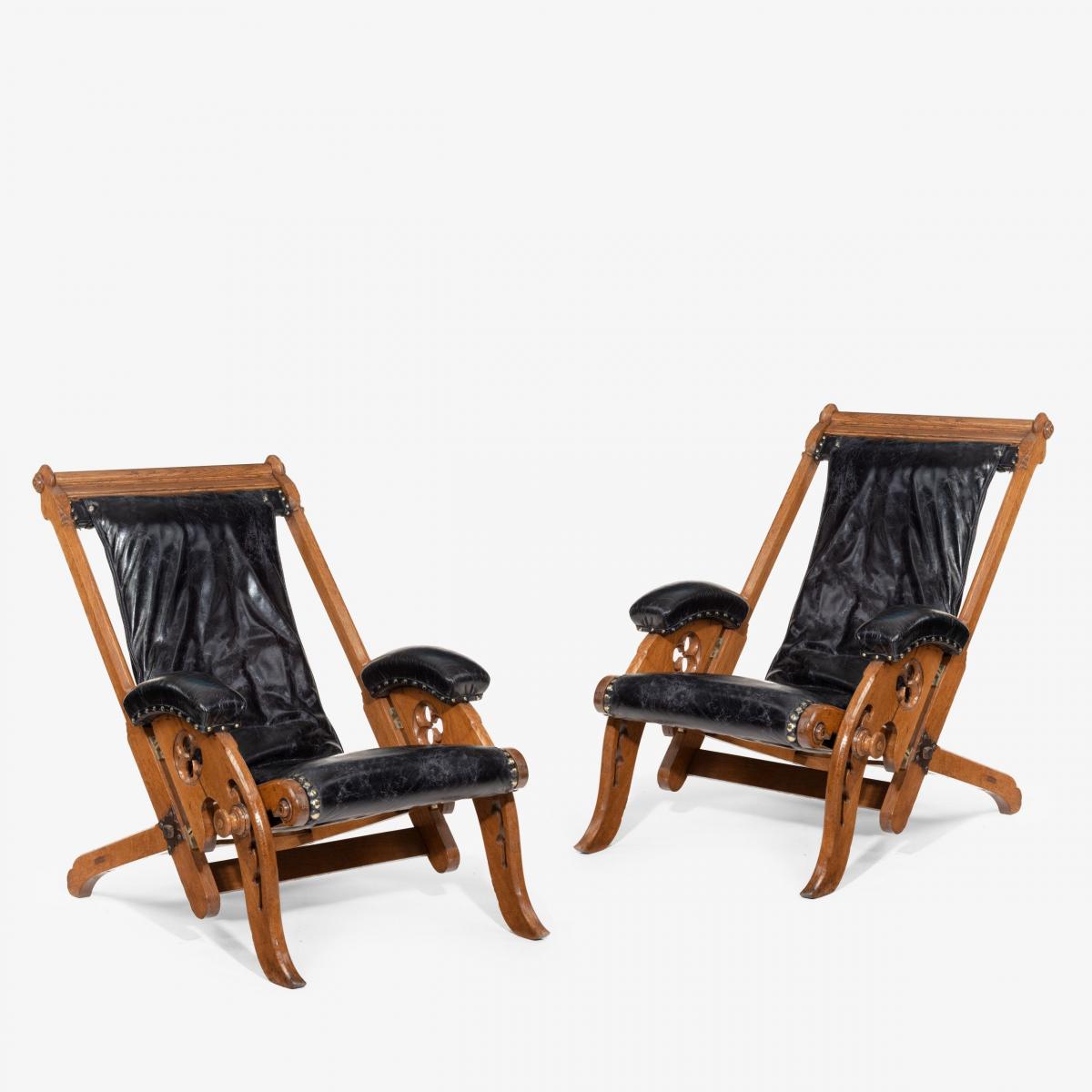 A pair of reclining Gothic oak library chairs