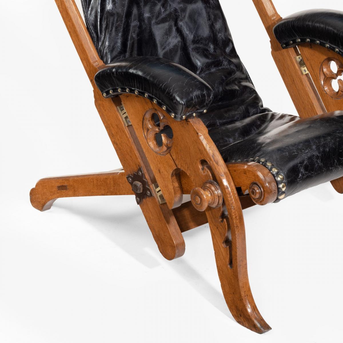 A pair of reclining Gothic oak library chairs