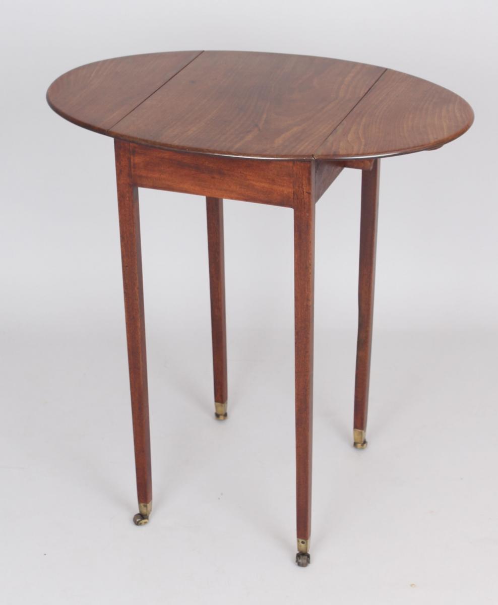 A George III period mahogany small oval Pembroke table