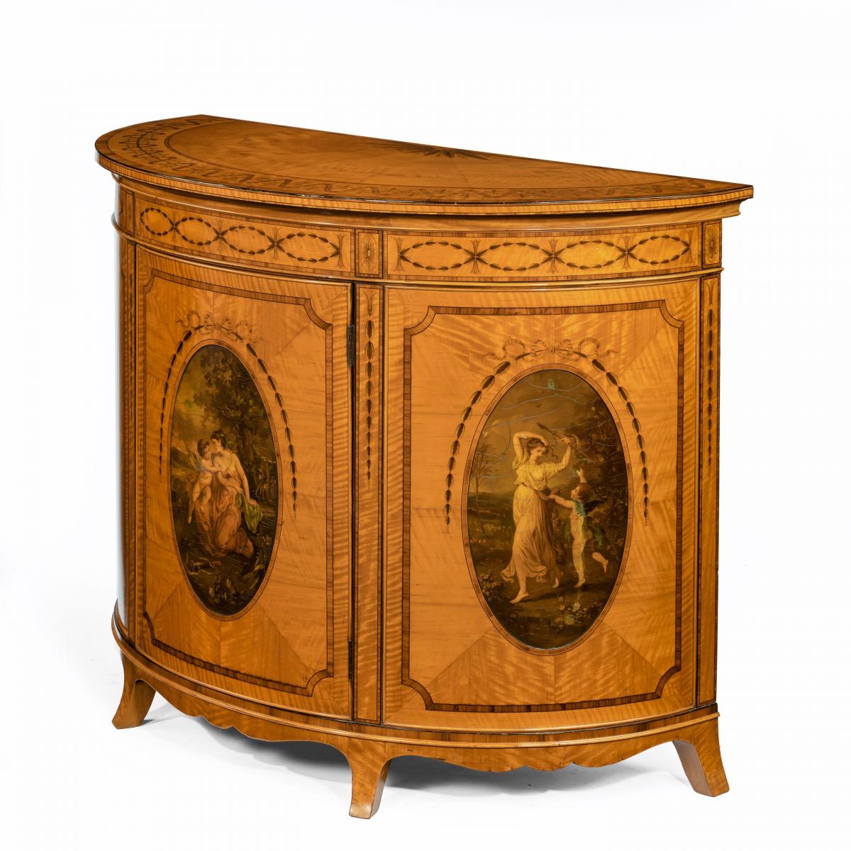 A fine Victorian Sheraton revival West Indian satinwood demi lune commode