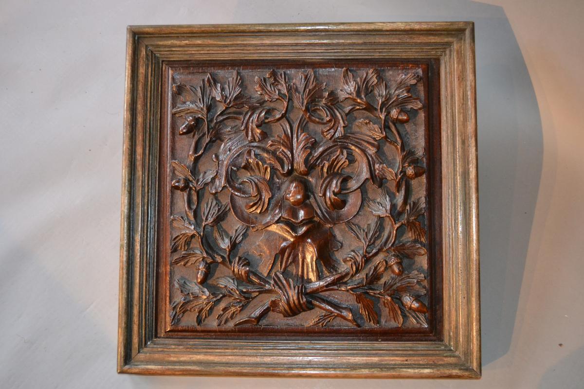 A large 18th century walnut carved panel depicting a "Green Man"