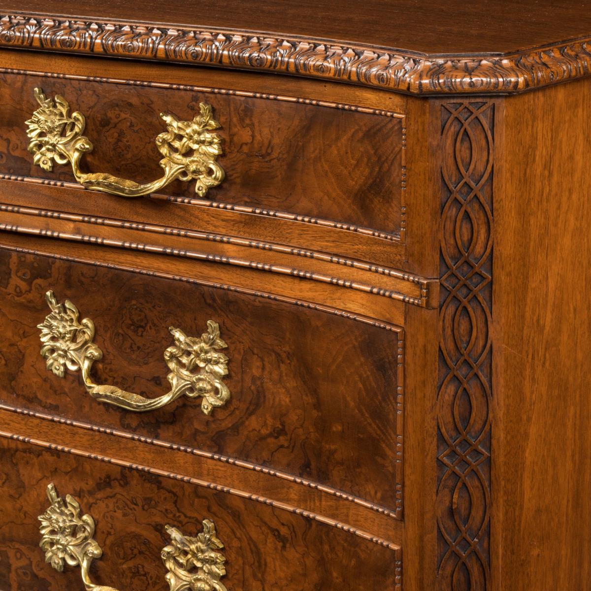 An unusual pair of early 20th century walnut serpentine commodes