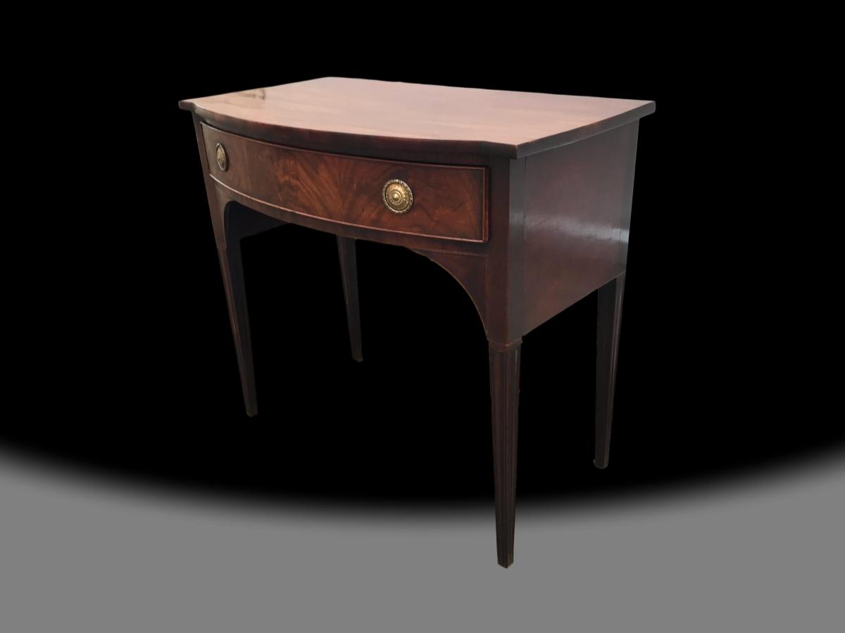 A George III bow front mahogany table