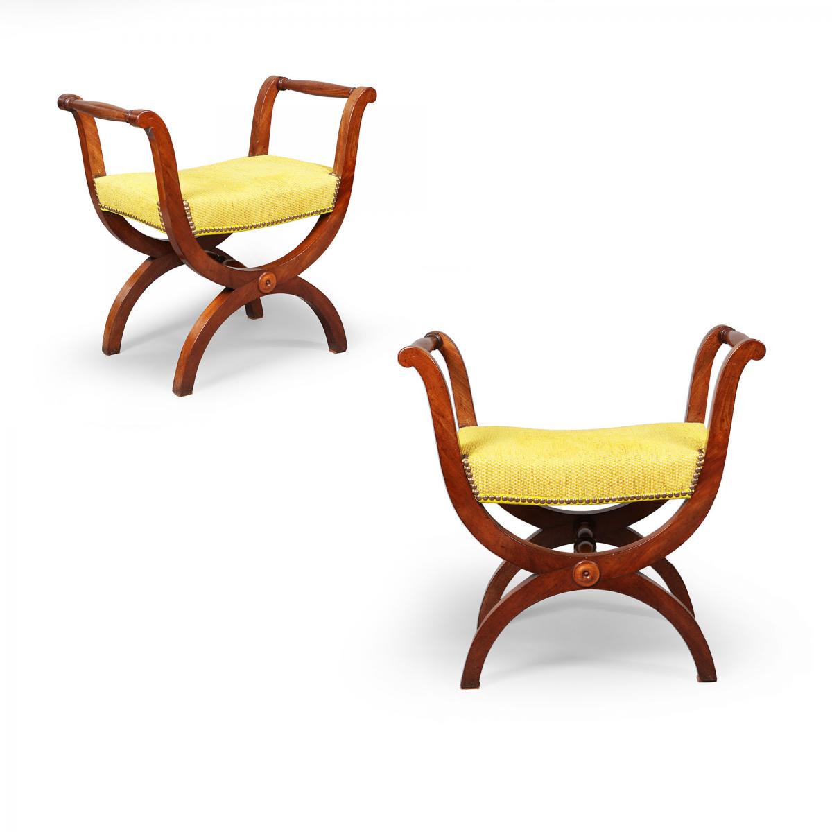A pair of mahogany X frame stools