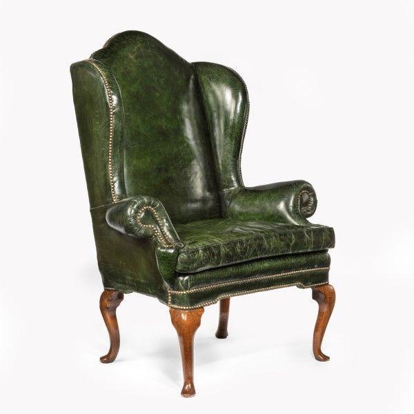 A George I walnut wing arm chair of generous proportions