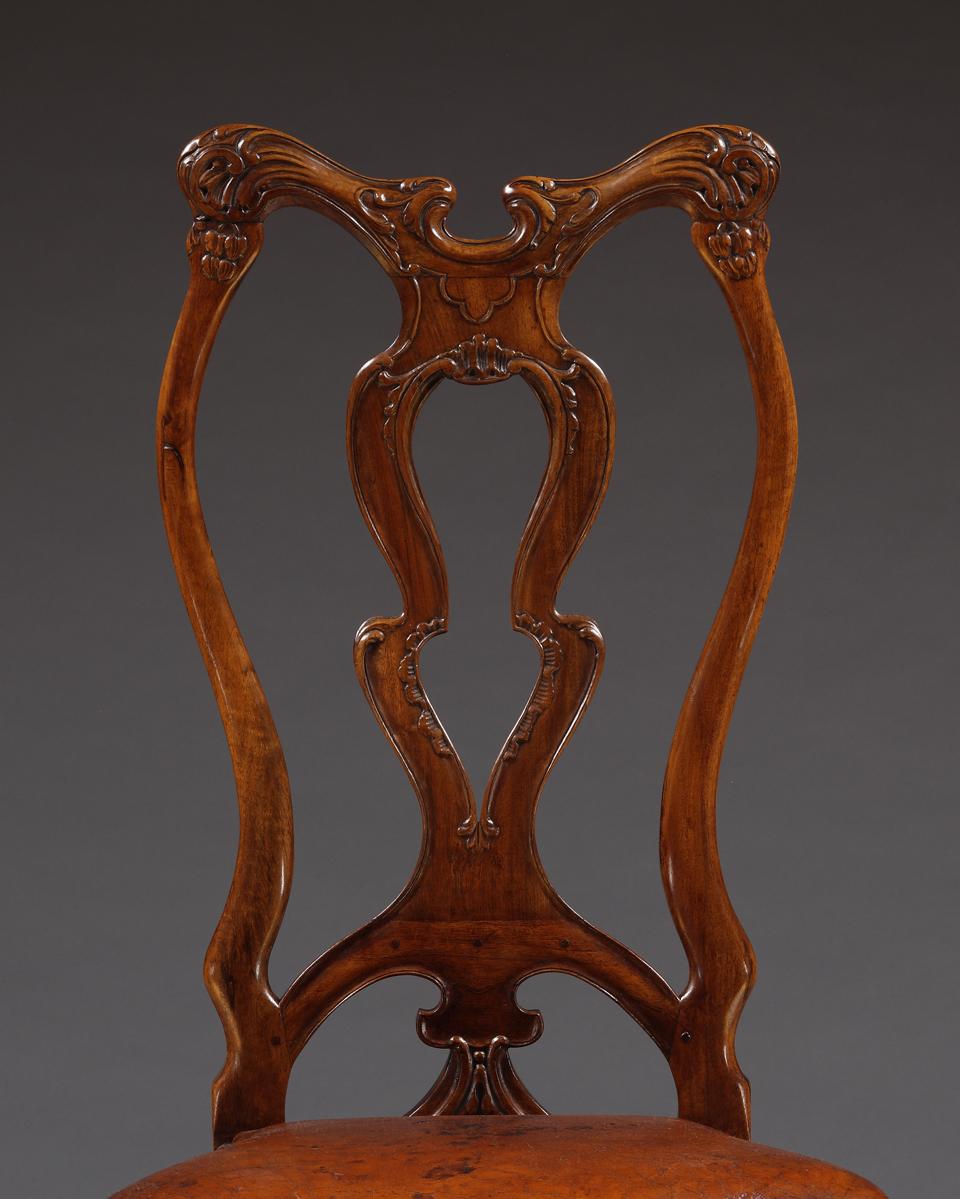 A Set Of Twelve Carved Walnut Dining Chairs Of Unusual Undulating Form