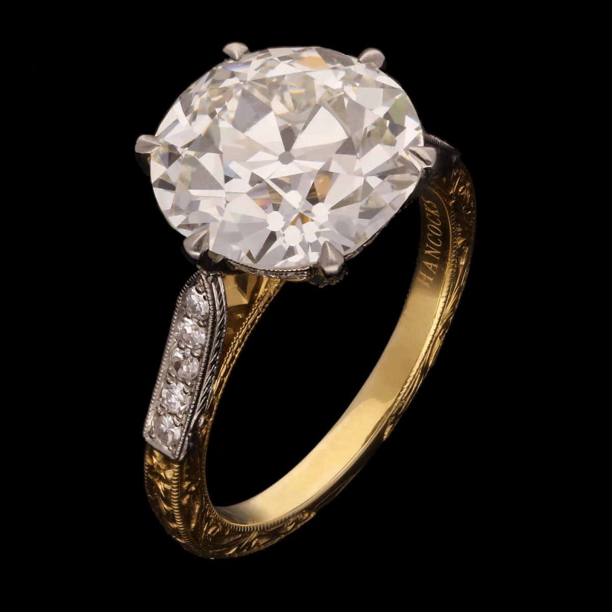 5.95ct old European brilliant cut diamond solitaire ring with diamond-set band.