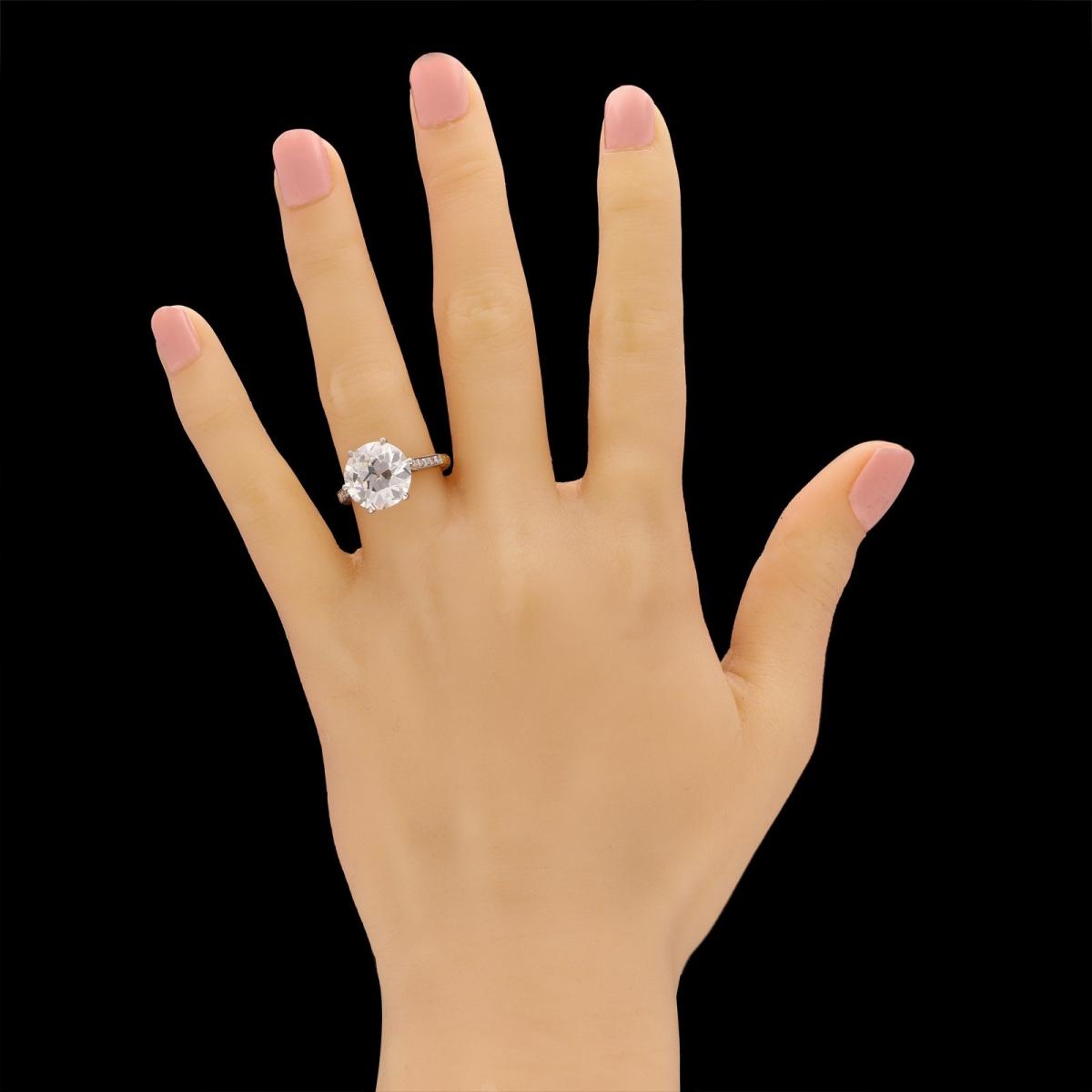 5.95ct old European brilliant cut diamond solitaire ring with diamond-set band.