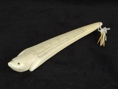 Whaler's seal-shaped cribbage board and counters_a