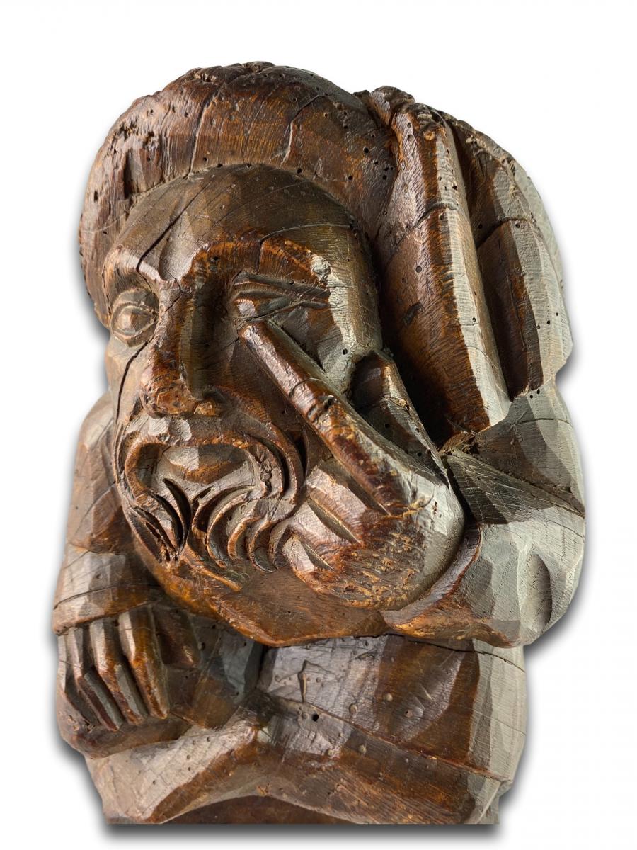 Corbel of a seated man in fashionable clothing. Northern France, 15th century