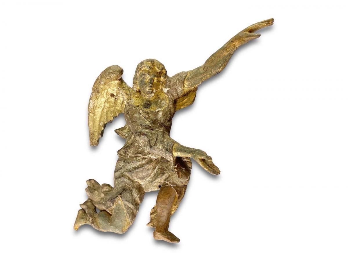 A pair of gilded oak reliefs of flying angels. French, late 17th century