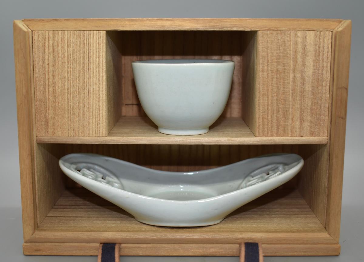 A small white glazed sake cup and tray