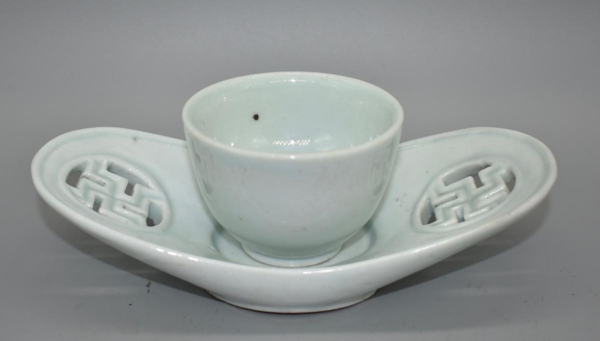A small white glazed sake cup and tray