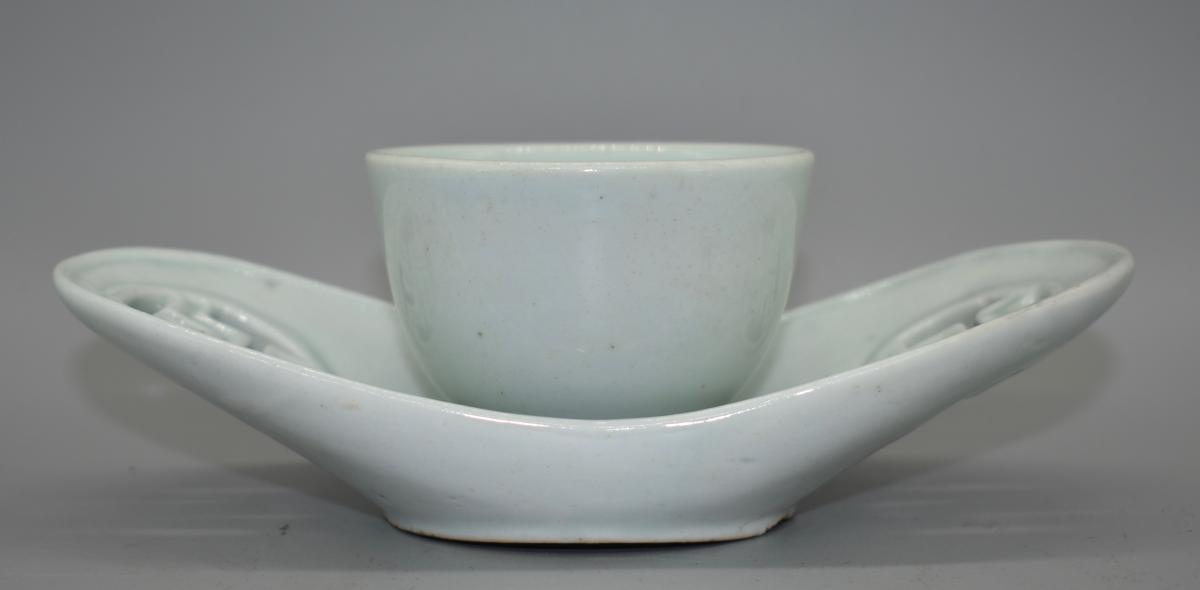 A small white glazed sake cup and tray