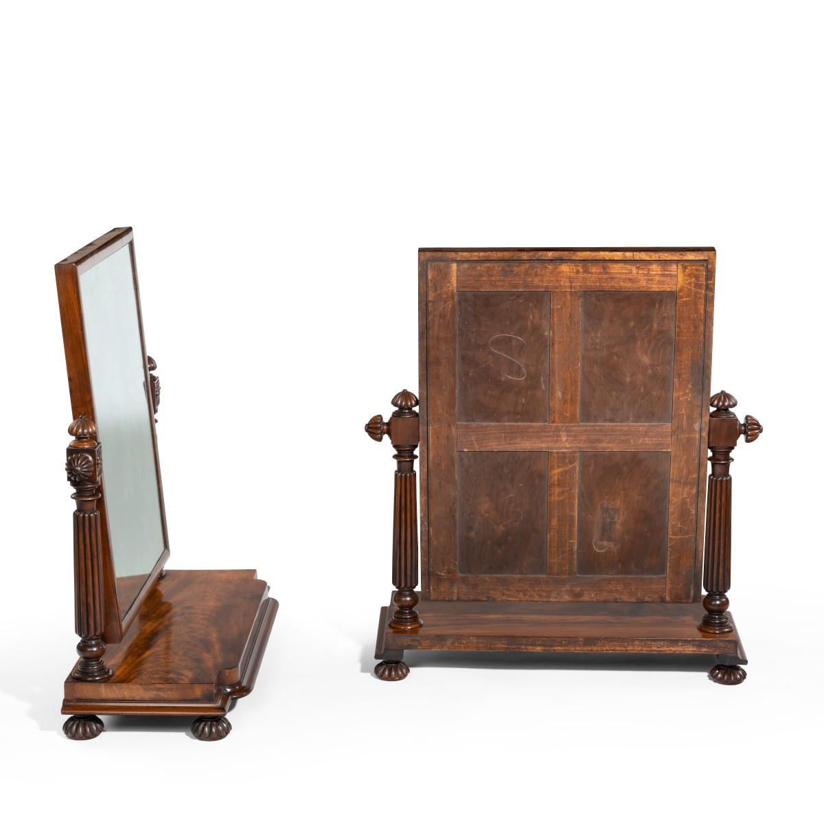 A pair of George IV mahogany table mirrors attributed to Gillows